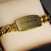 Texas Hold'em gold poker bracelet with ace of spades charm on white background